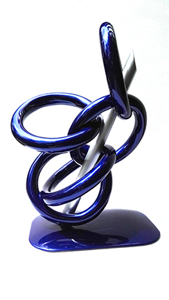 A Sculpture Made Of Metal Of Large Interlocking Circles With A Silver Pole In The Center By The Artist Ilse De Manzanarez.